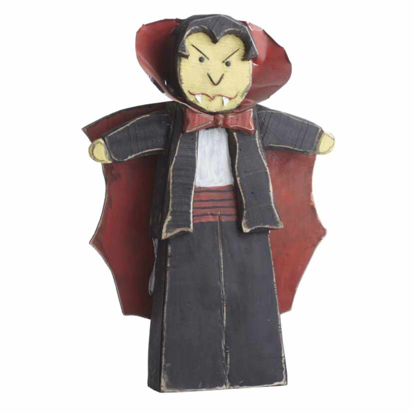 Vampire voodoo A quirky vampire of hand-painted, weathered wood with metal cape and collar...
