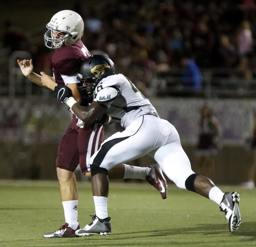 (TXHSFB) Plano East defensive lineman Landis Durham (46) pressures Plano quarterback Quinn...