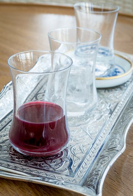 Raki, a potent anise-flavored Turkish liquor, is served on a silver tray with ice and water.