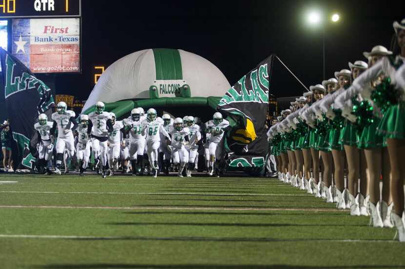 Lake Dallas runs onto the field during the start of the area round of the 2015 UIL State...