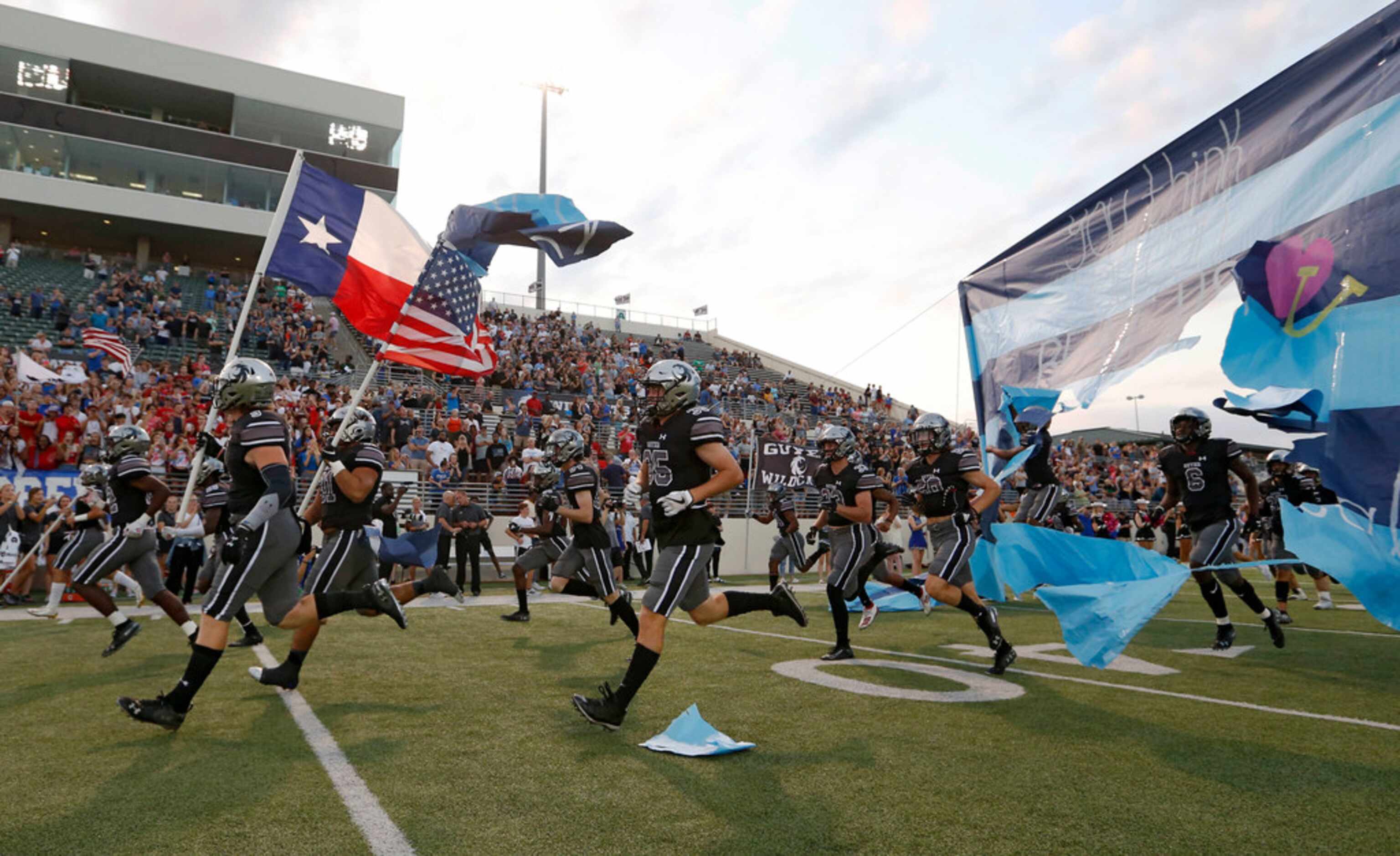 Denton Guyer takes the football field during introductions before a football game against...