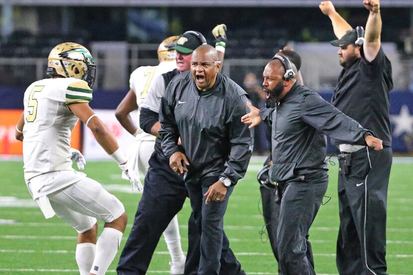 DeSoto coaches celebrate a defensive stop with Byron Hanspard Jr. (5) during the Eagles's...