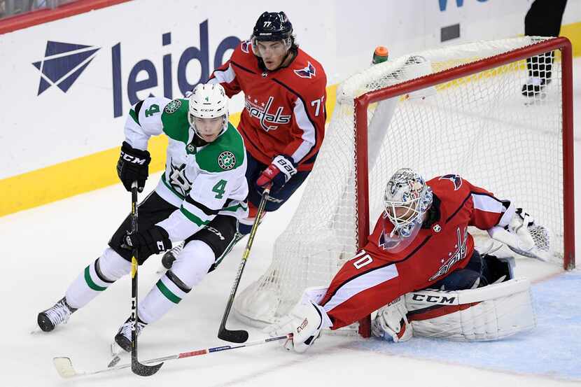 Washington Capitals goaltender Braden Holtby (70) reaches for the puck against Dallas Stars...