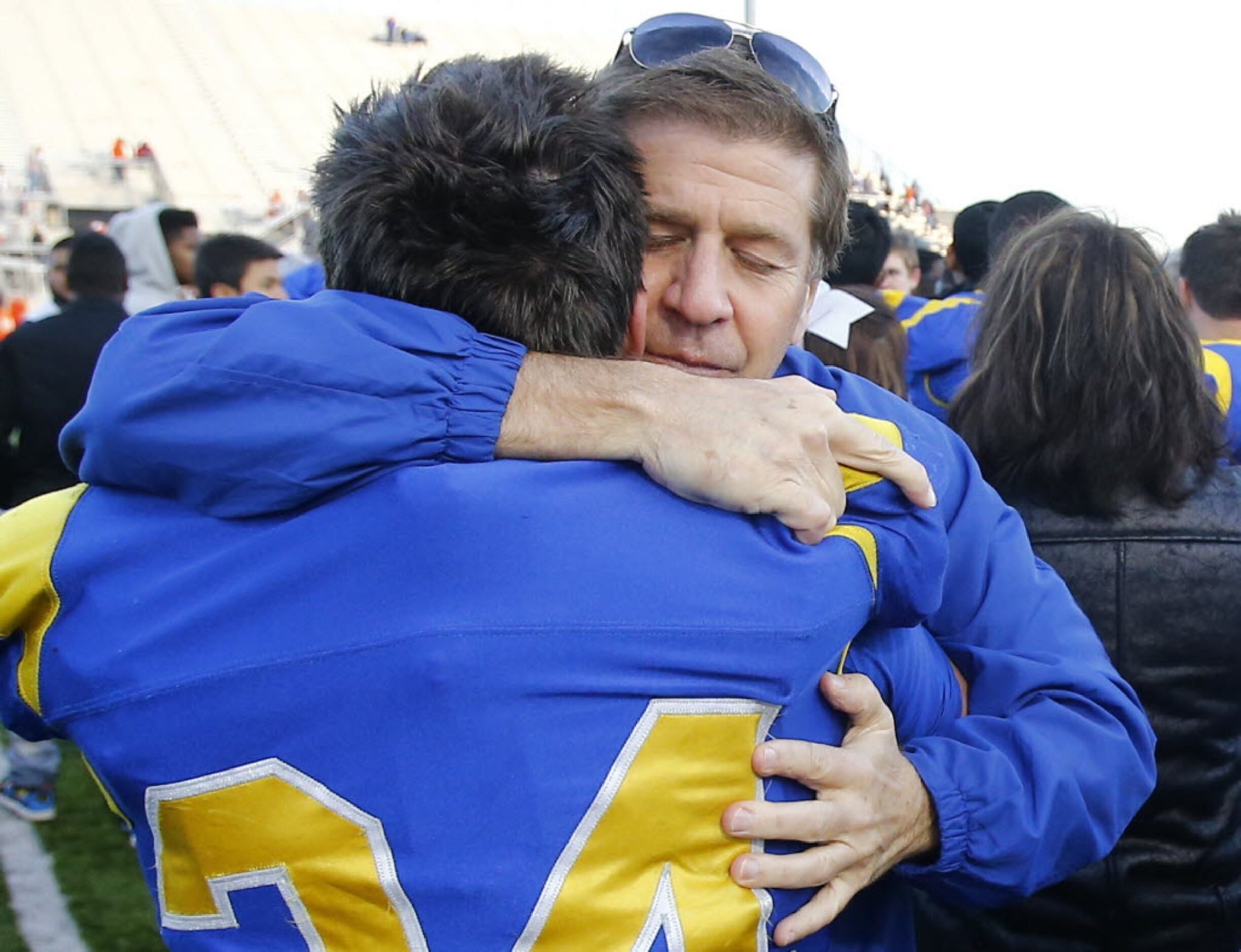 Sunnyvale superintendent Doug Williams hugs Garrett Ferguson (34) following their loss to...