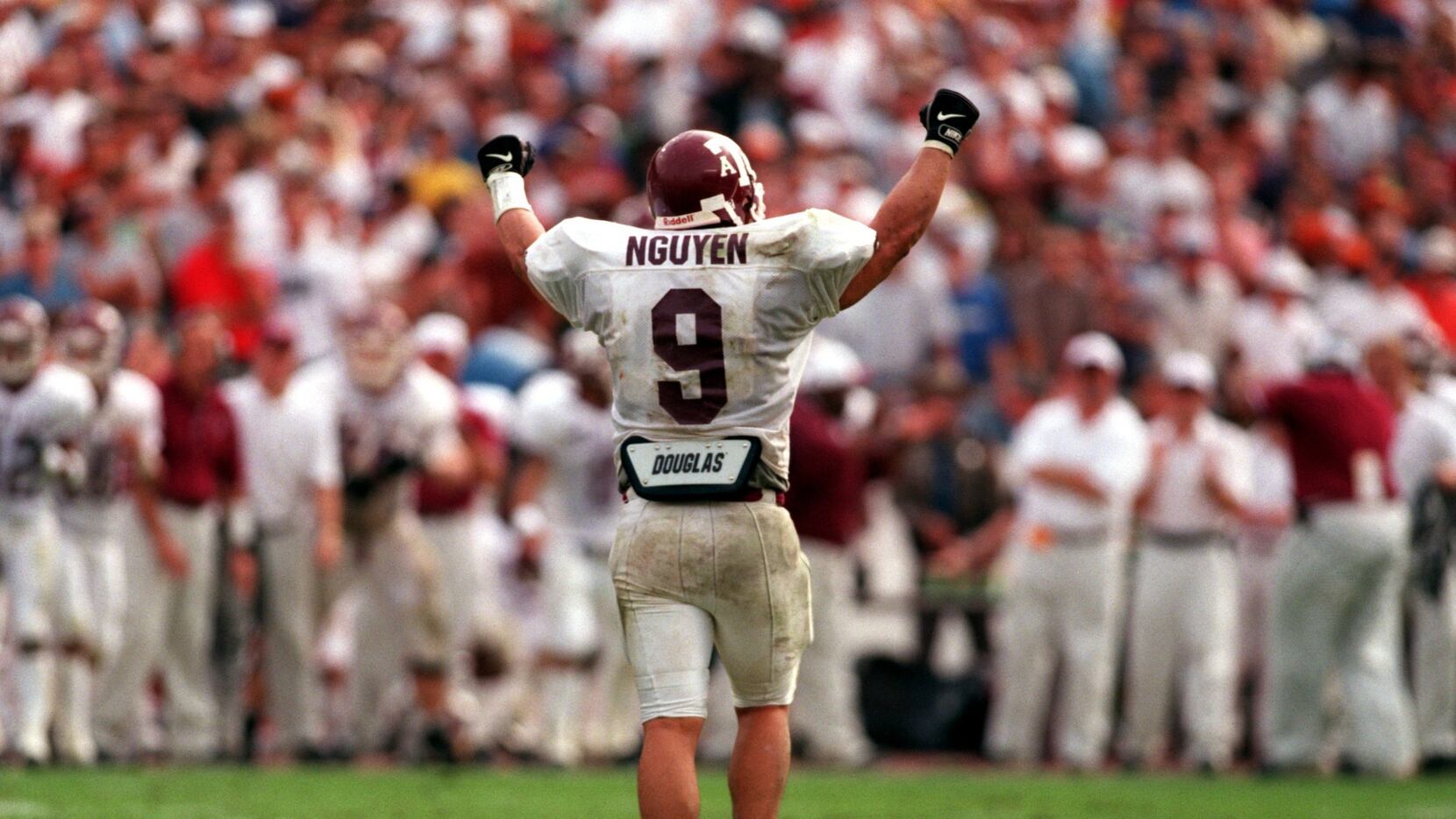 Texas A&M's Dat Nguyen looks back at the A&M bench celebrating after A&M's defense rattled...