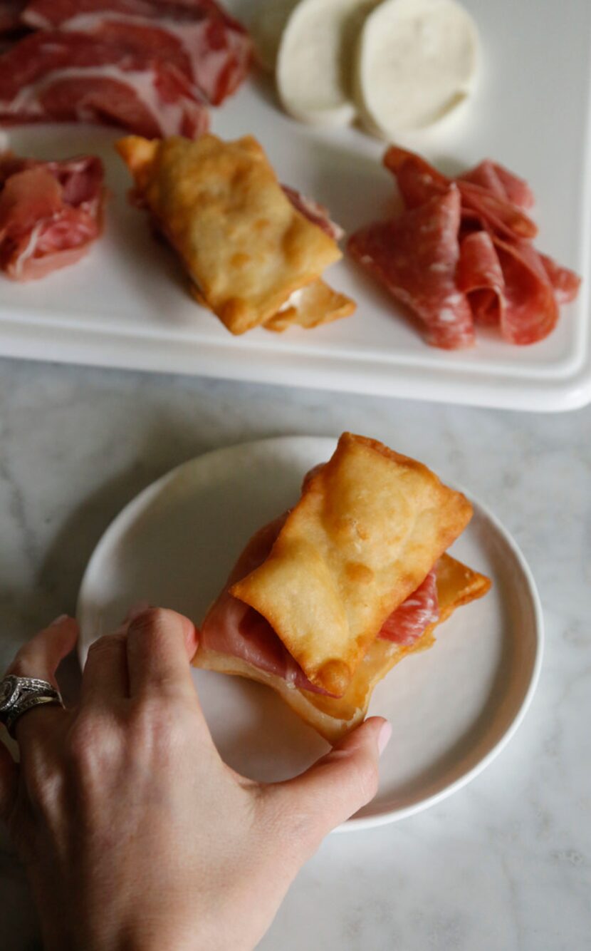 Gnocco fritto is a traditional Italian dish made of fried dough served with salumi and cheese.