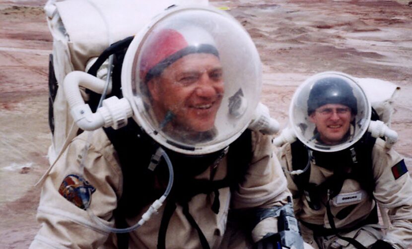 Dr. Vladimir Pletser and Jan Osburg climb a hill while exploring in 2002 outside The Mars...