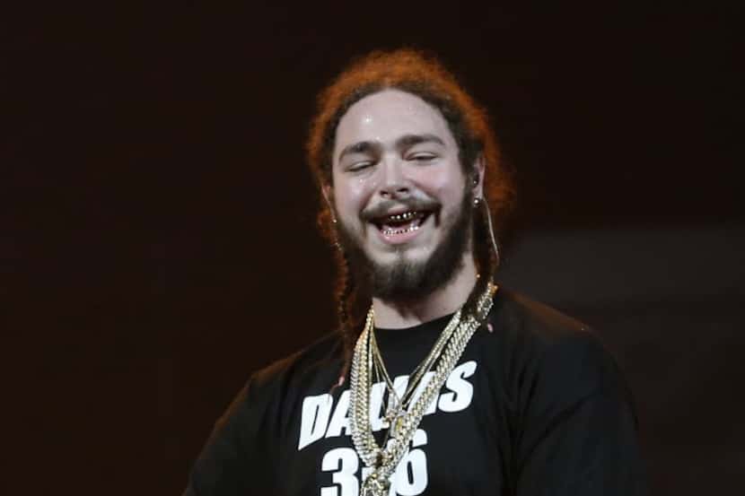 Post Malone smiles while performing onstage in the opening acts during the Justin Bieber...
