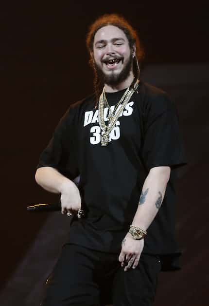 Post Malone smiles while performing onstage in the opening acts during the Justin Bieber...