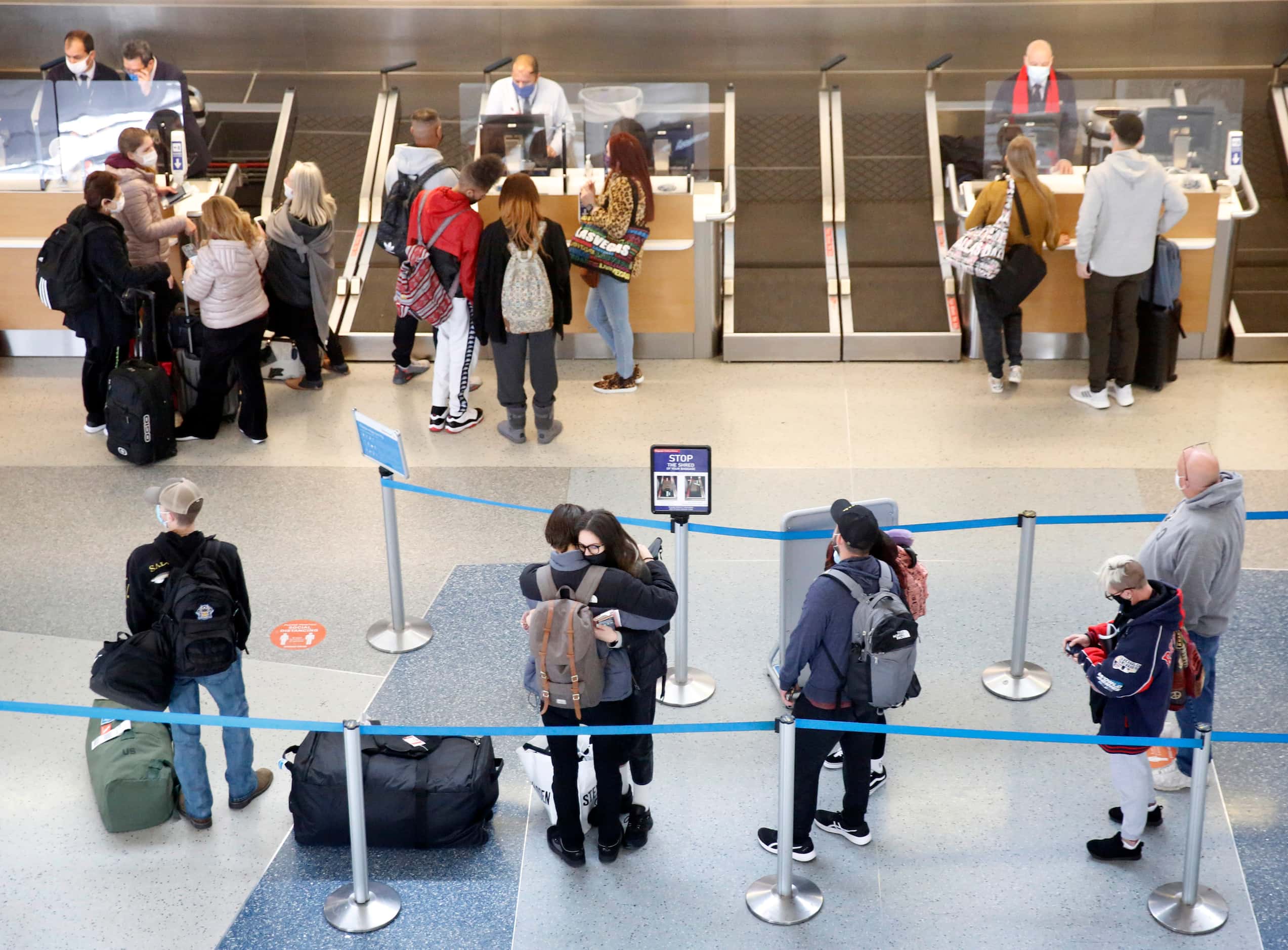 A short line of passengers check in for their flight at DFW Airport’s Terminal D where...