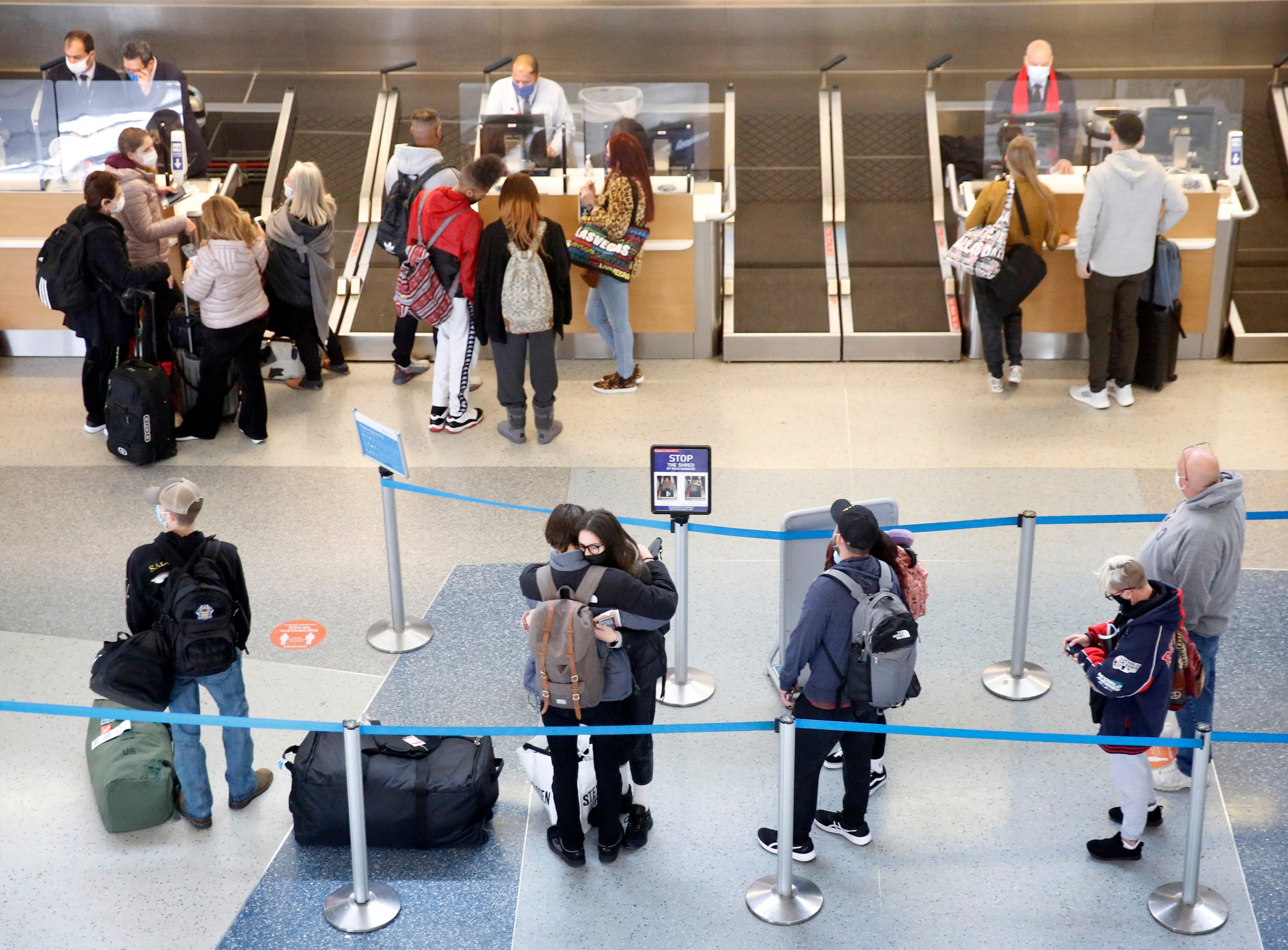 A short line of passengers check in for their flight at DFW Airport’s Terminal D where...