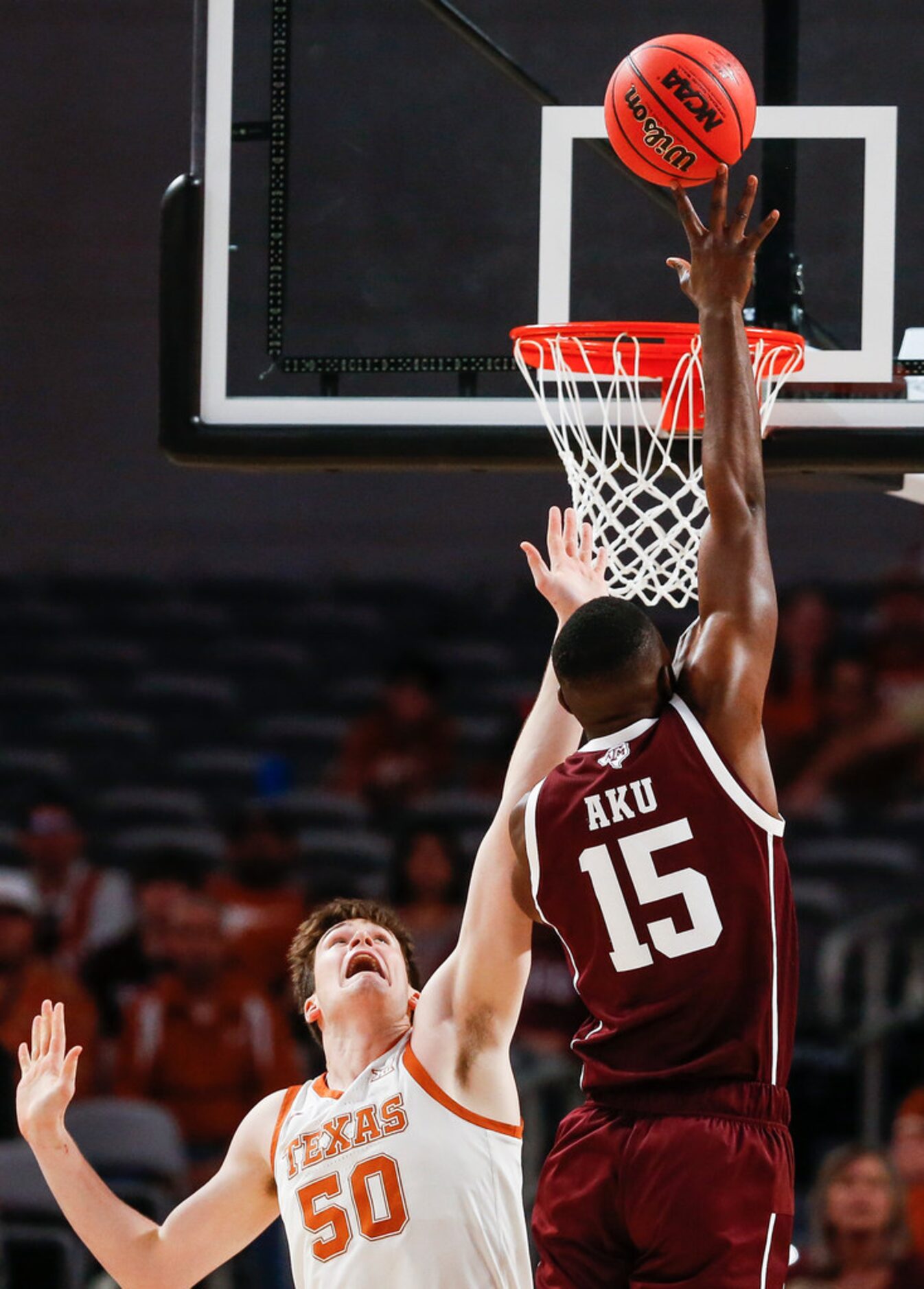 Texas A&M Aggies forward Jonathan Aku (15) takes up a shot over Texas Longhorns center Will...