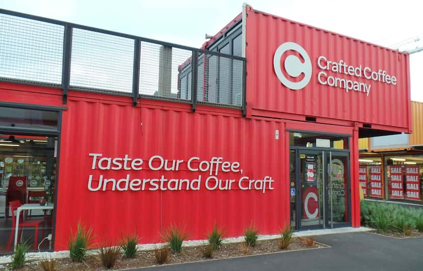 Crafted Coffee Company has welded together several shipping containers to create a two-story...