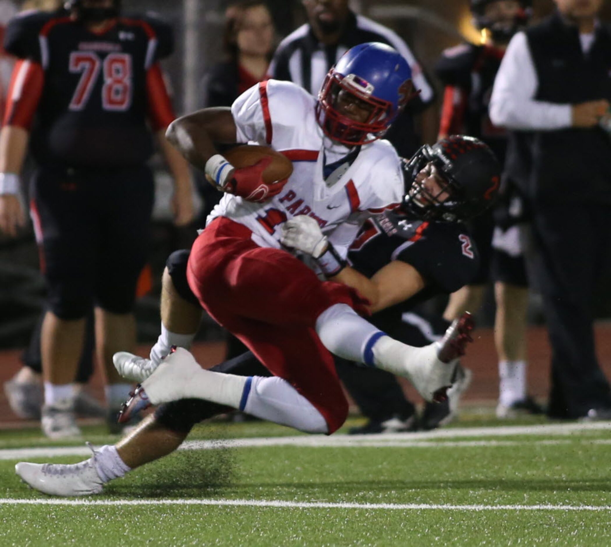 Parish Episcopal’s Justin Morris (11) is tackled by Fort Worth Christian’s Kallan Walters...