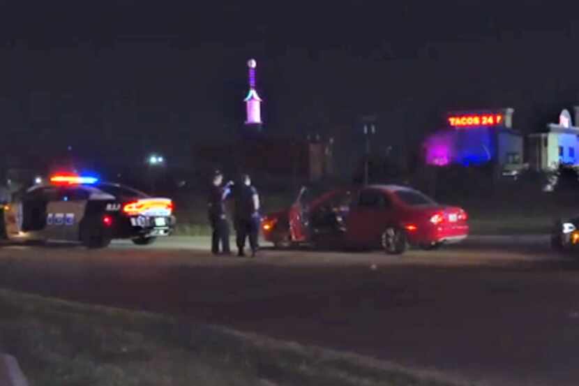 Officers investigate the shooting scene. Dallas police are looking for two men who were seen...