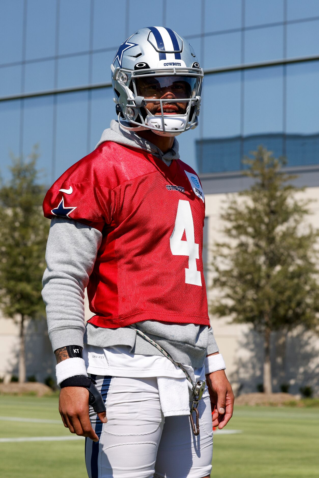 Dallas Cowboys quarterback Dak Prescott (4) talks with reporters while wearing a brace on...