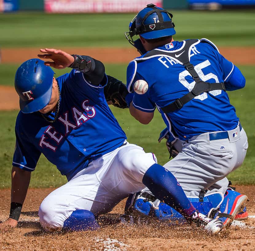Texas Rangers designated hitter Shin-Soo Choo scores as the ball gets away from Los Angeles...
