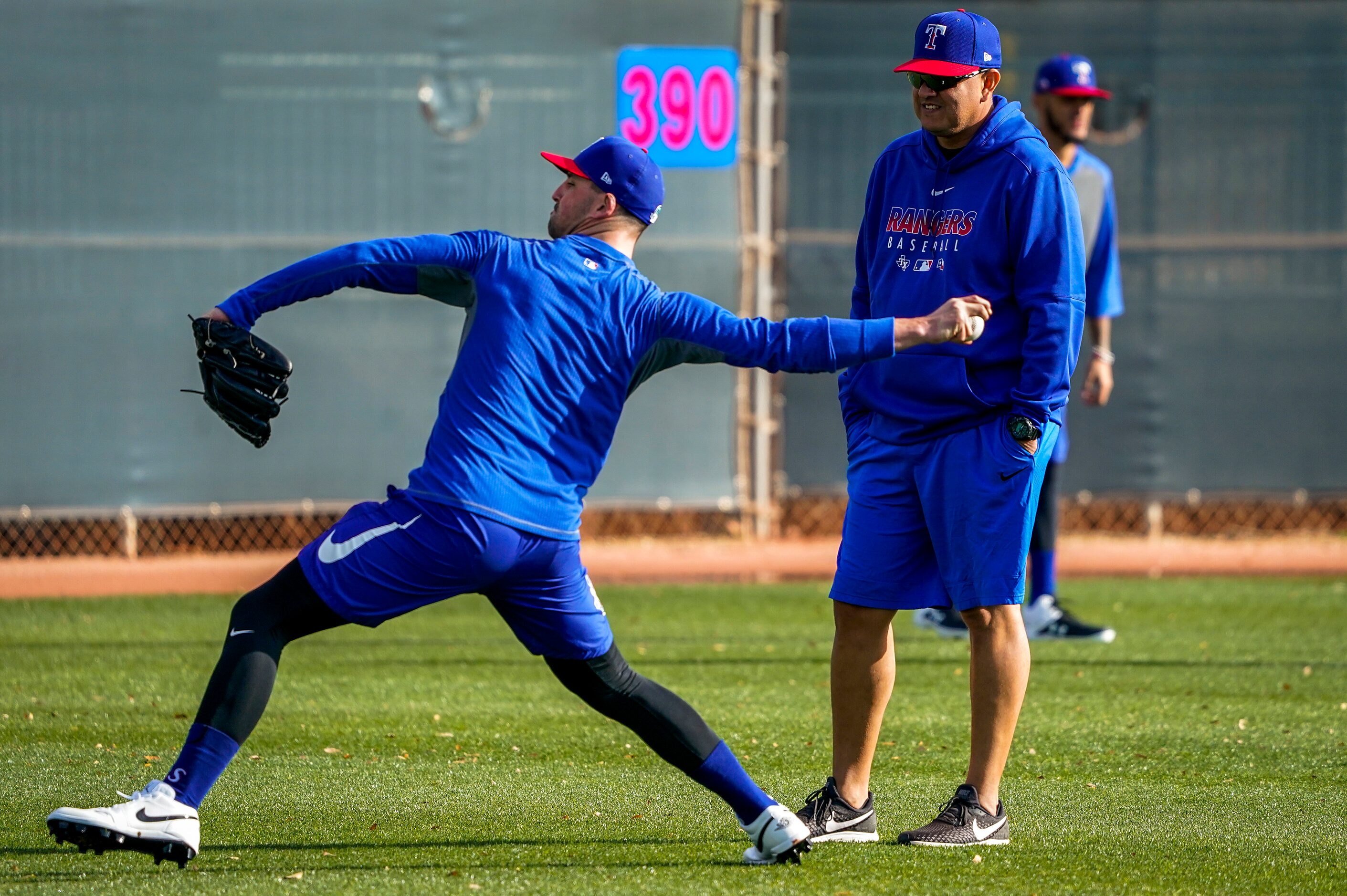 Texas Rangers pitching coach Julio Rangel (right) watches pitcher Taylor Guerrieri play...