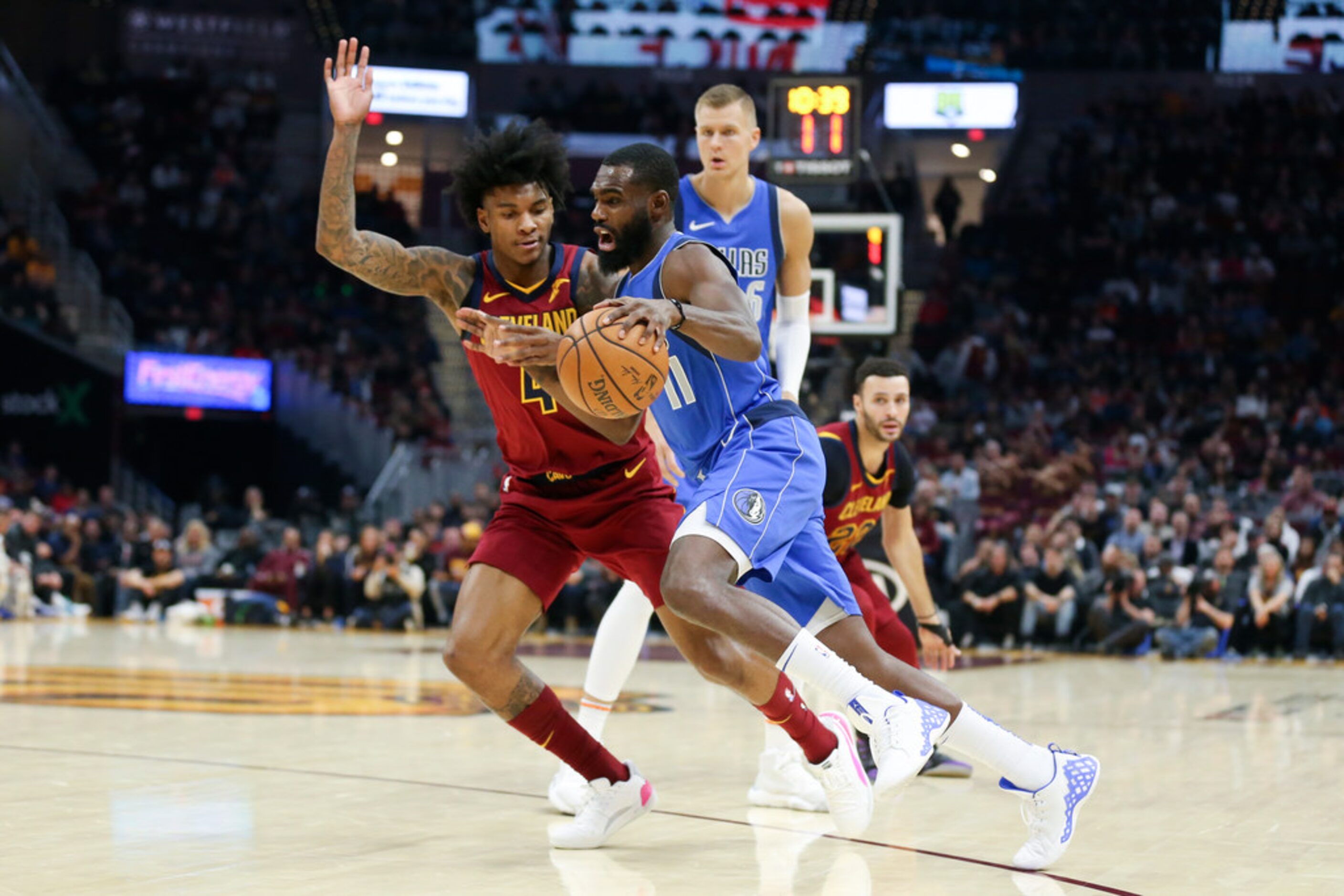 Dallas Mavericks' Tim Hardaway Jr. drives on Cleveland Cavaliers' Kevin Porter Jr. in the...