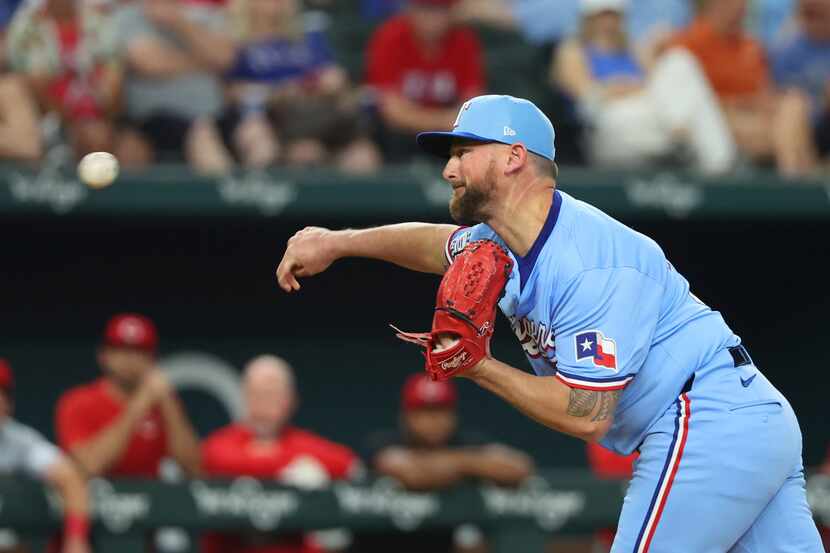 Texas Rangers relief pitcher Kirby Yates delivers against the Cincinnati Reds in the ninth...