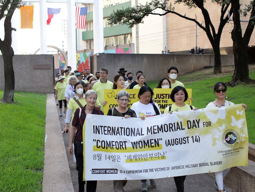 Community members march through downtown to Thanksgiving Square as part of the International...