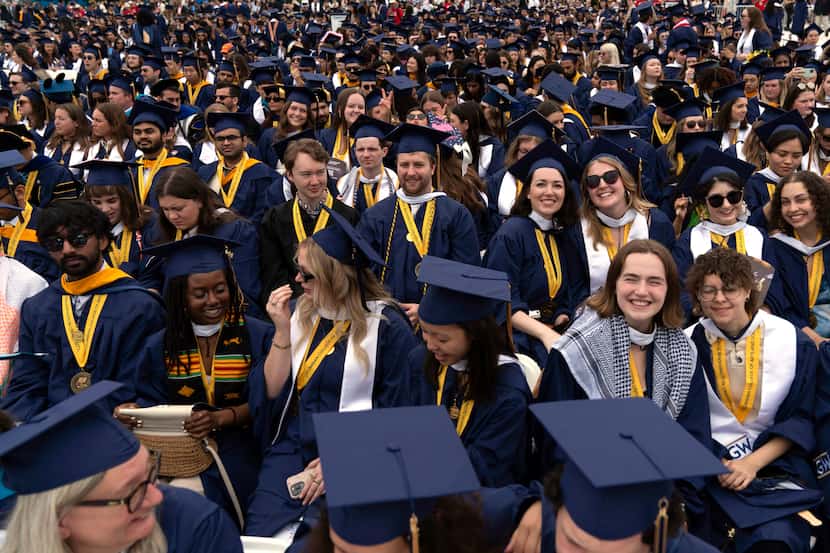 Graduating George Washington University students attend a commencement ceremony in...