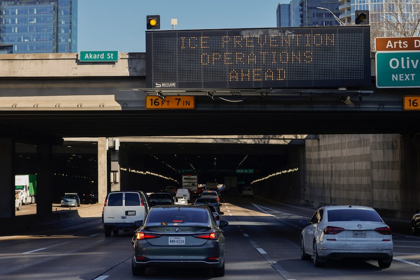 A TxDOT sign warns drivers of work crews conducting ice prevention operations along Woodall...