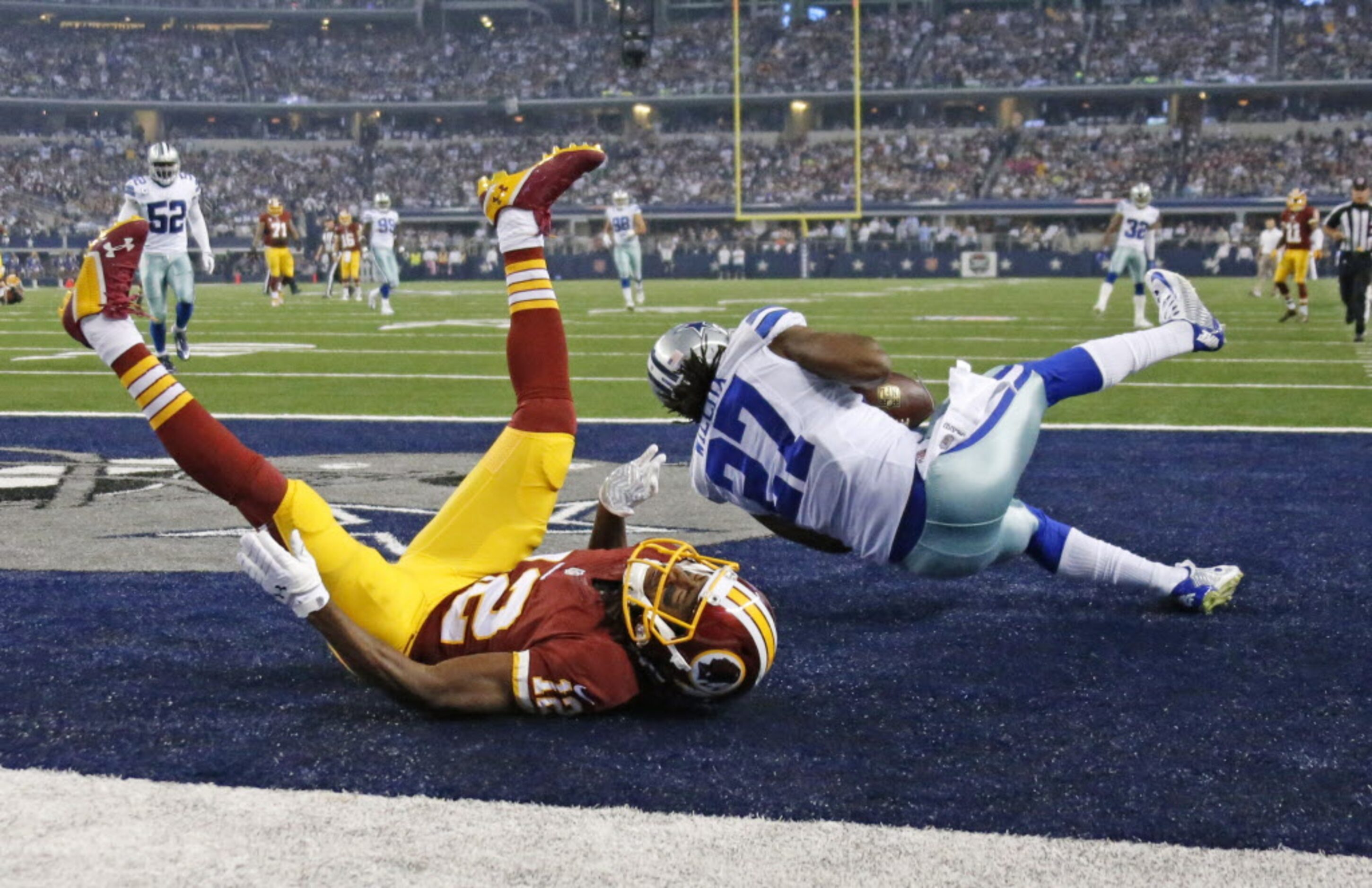 Dallas Cowboys strong safety J.J. Wilcox (27) intercepts a pass intended for Washington...