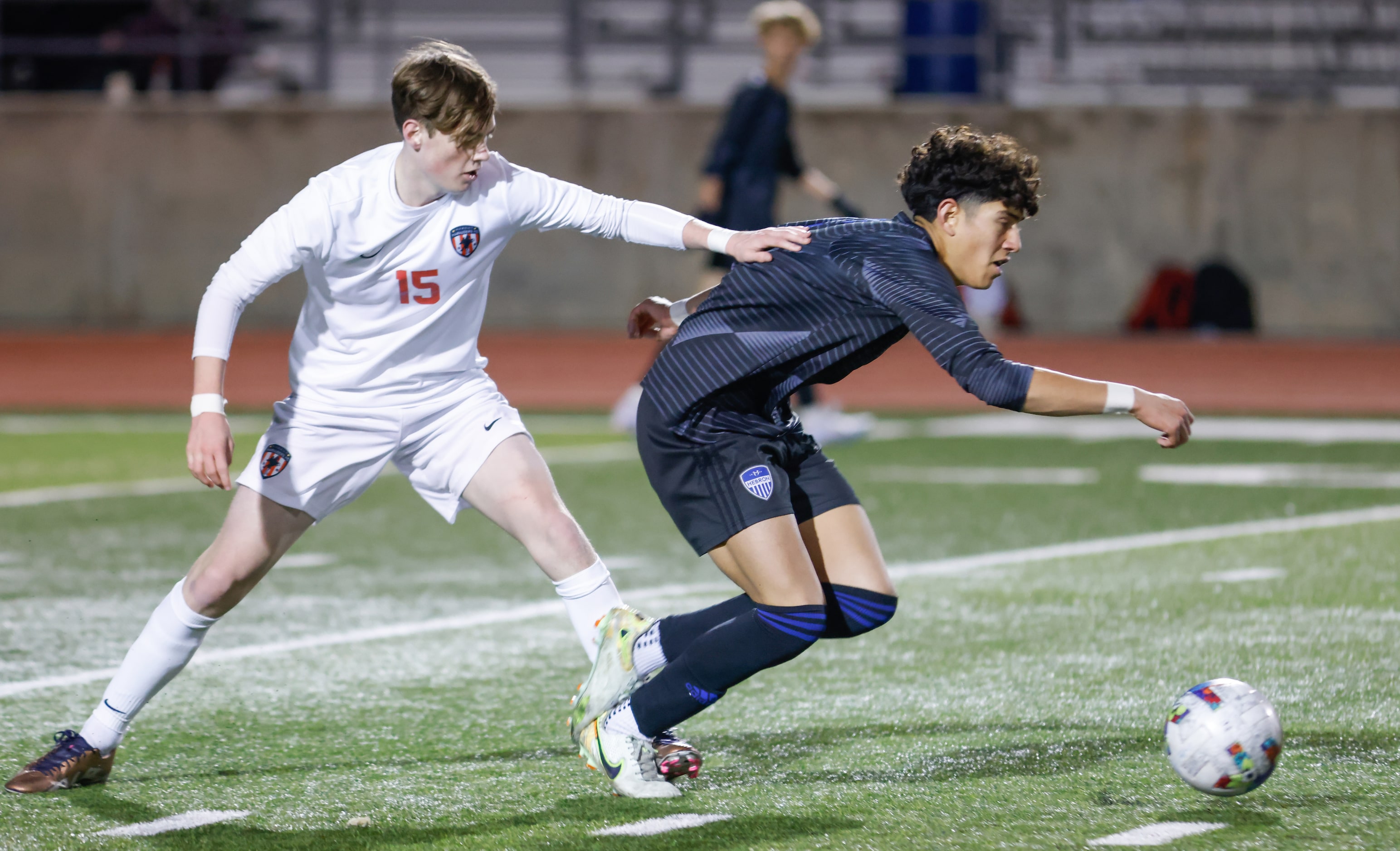 Flower Mound Marcus’ Chase Ficke (15) pushes Hebron’s Evan Kelley (3) during a game at...