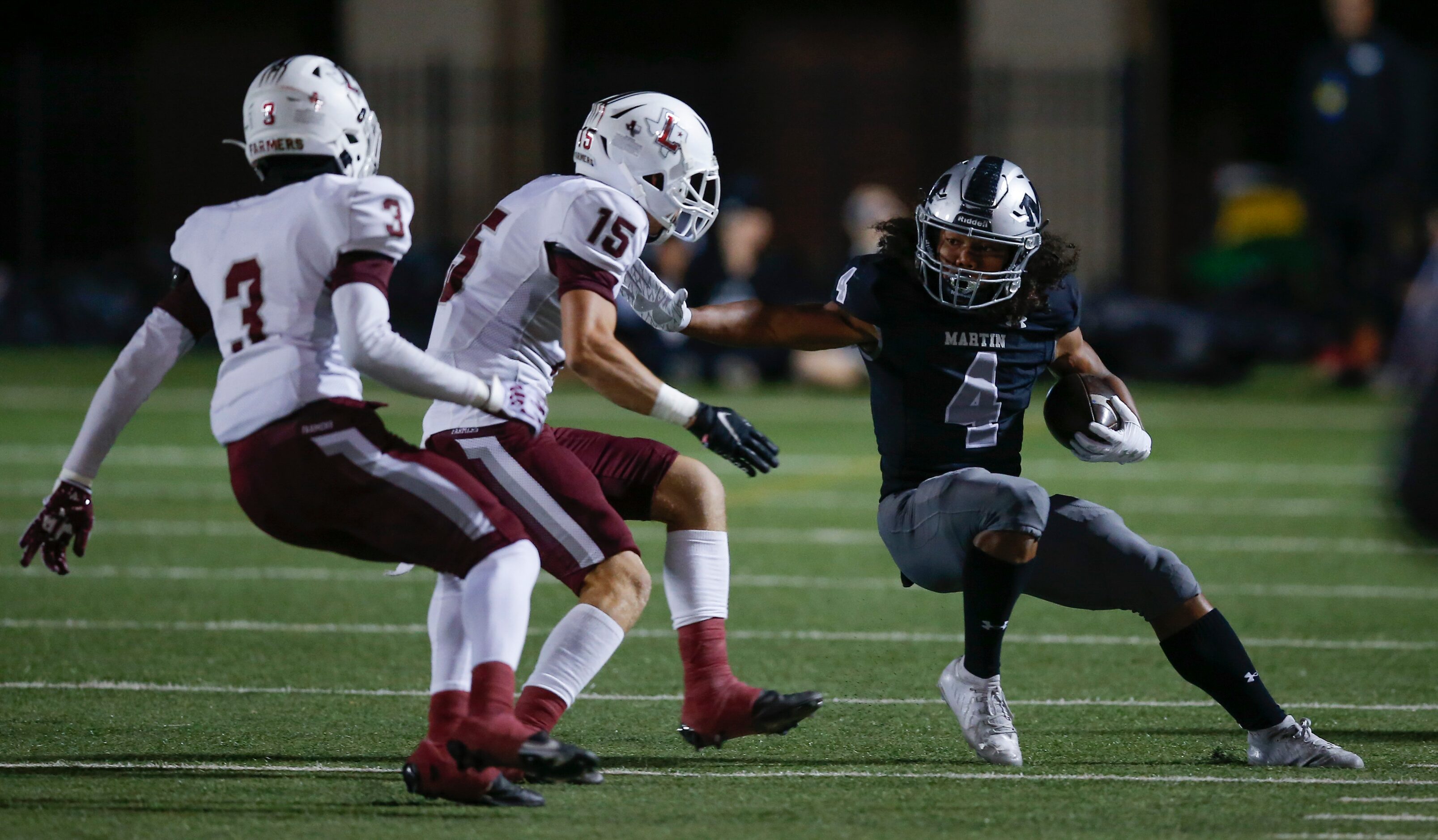 Arlington Martin junior Zaire Barrow (4) looks for room against Lewisville senior linebacker...