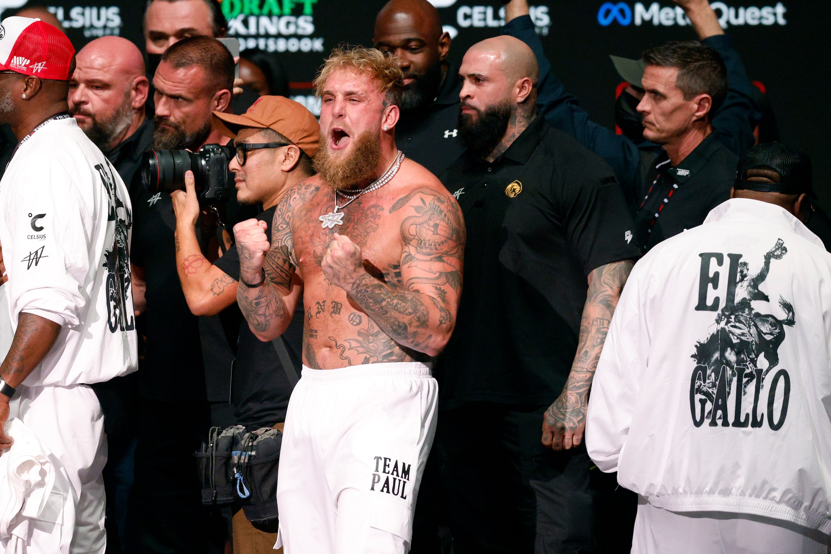 Jake Paul reacts after being slapped by Mike Tyson as they faced-off during public weigh-ins...