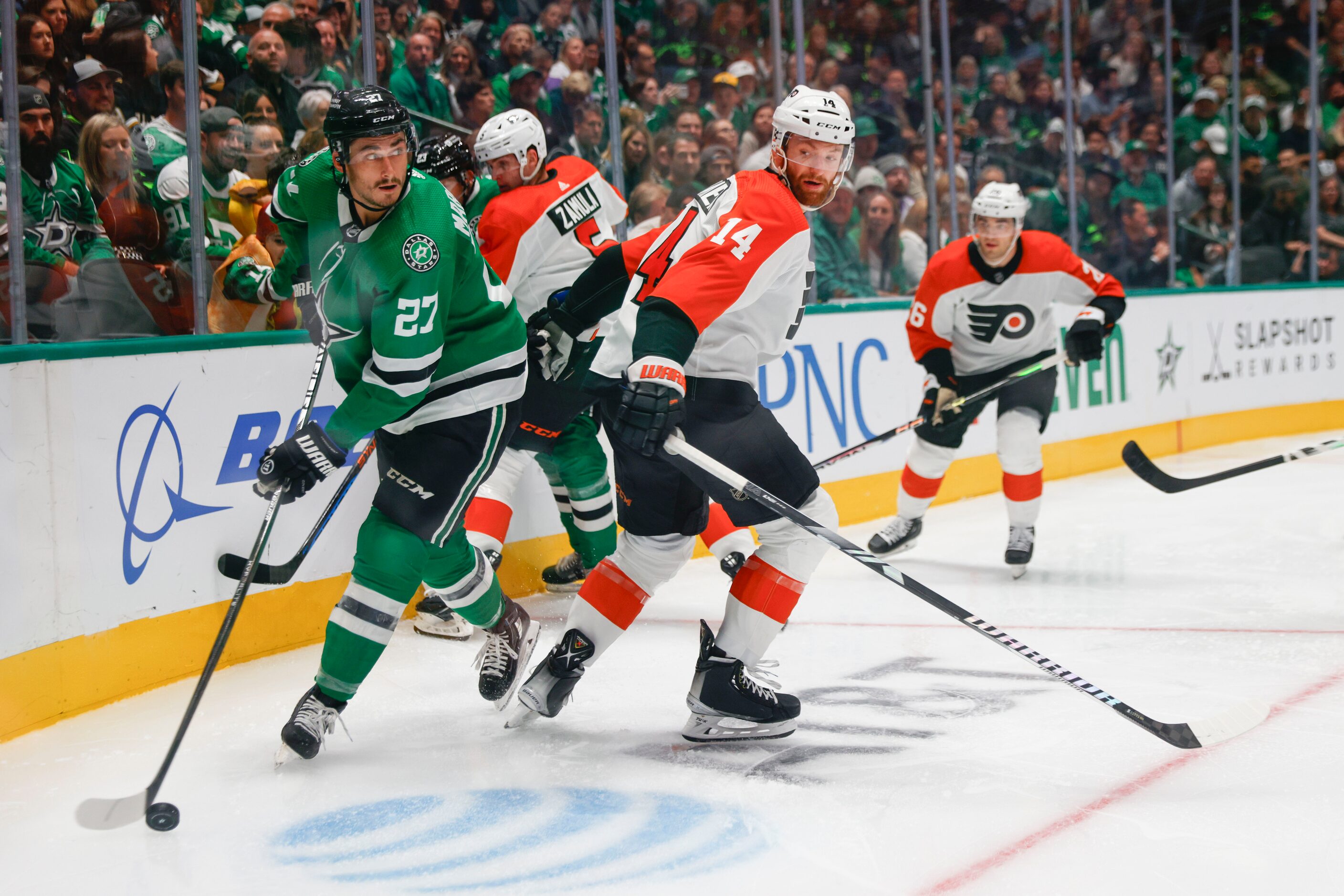 Dallas Stars left wing Mason Marchment (left) handles the puck against Philadelphia Flyers...