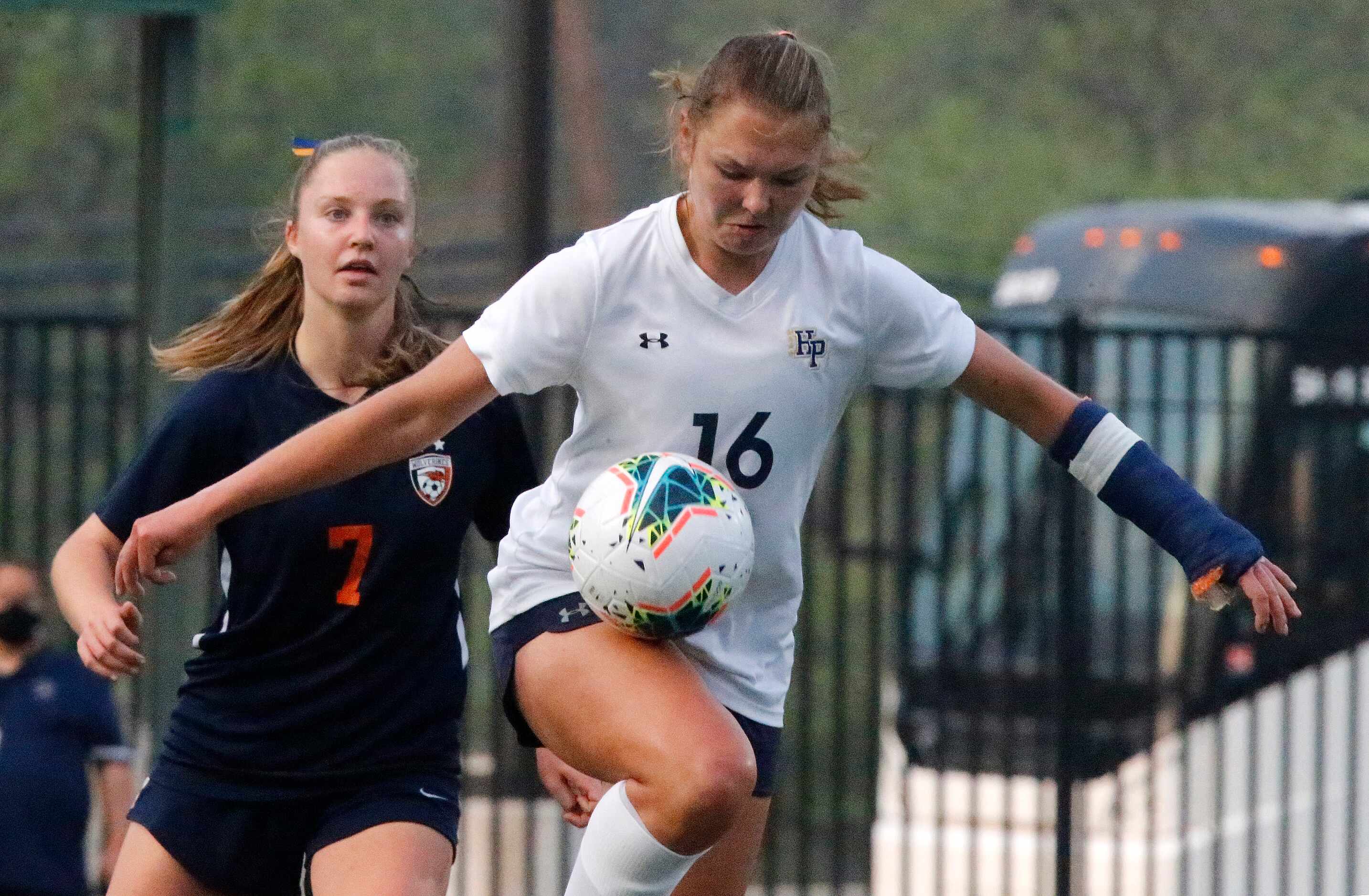 Highland Park midfielder Quinn Cornog (16) controls the ball in front of  Wakeland defender...