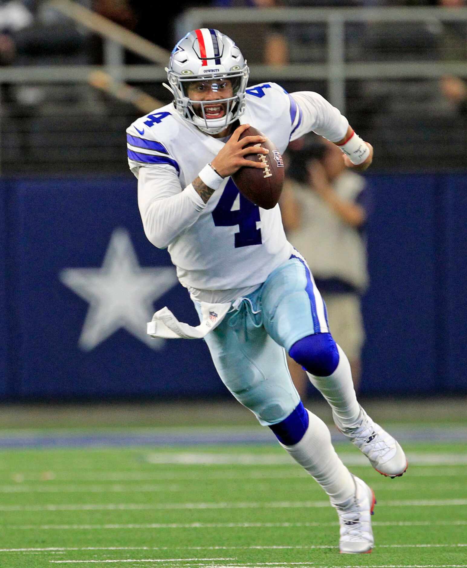 Dallas Cowboys quarterback Dak Prescott (4) scrambles for yards during the second half of a...
