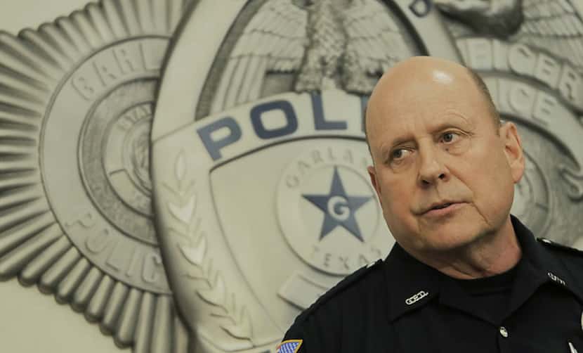 Garland police spokesman Joe Harn answers questions during a press conference Monday...
