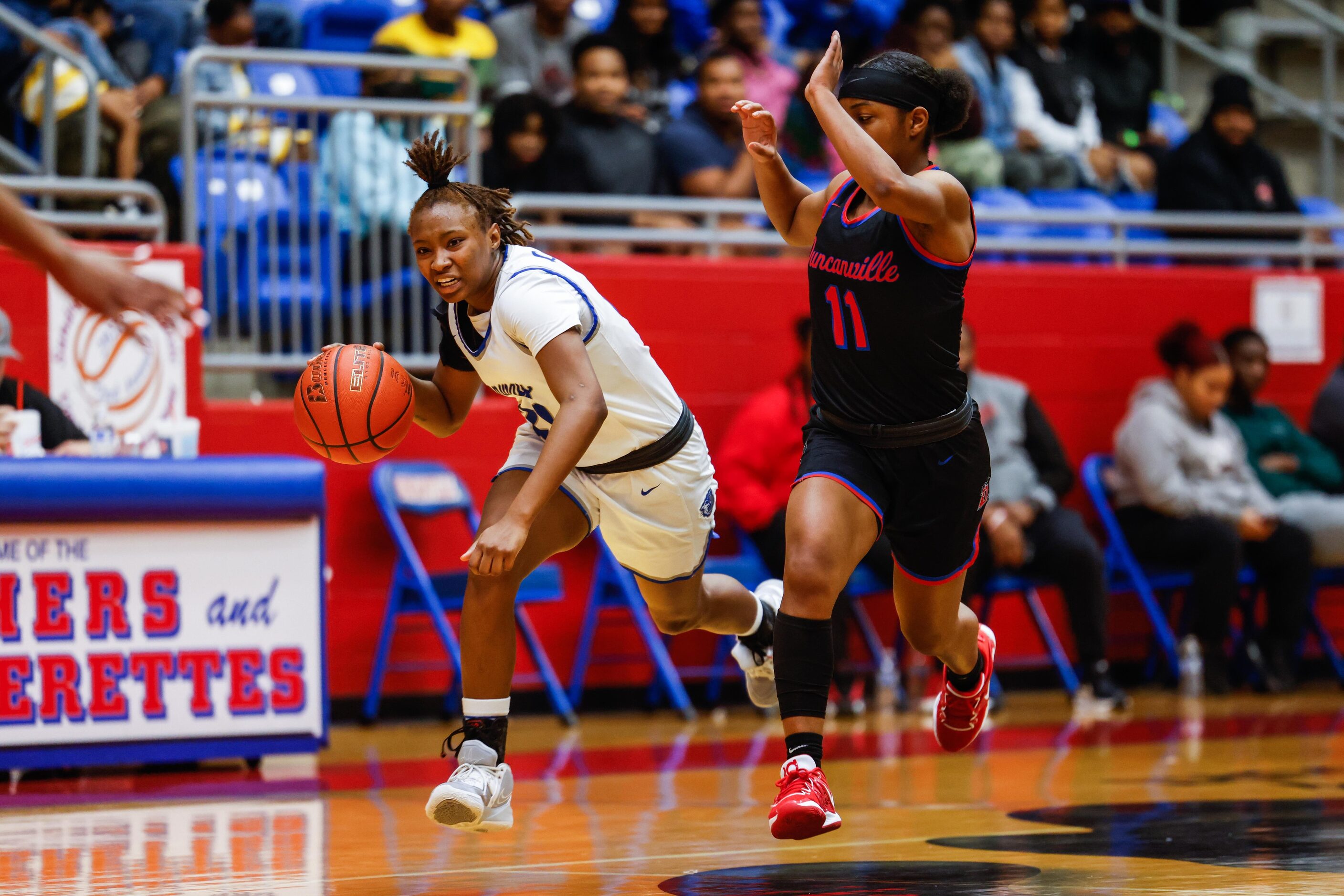 Conway Lady Cats Kamile Brown (21) dribbles the basketball against Duncanville Pantherettes'...