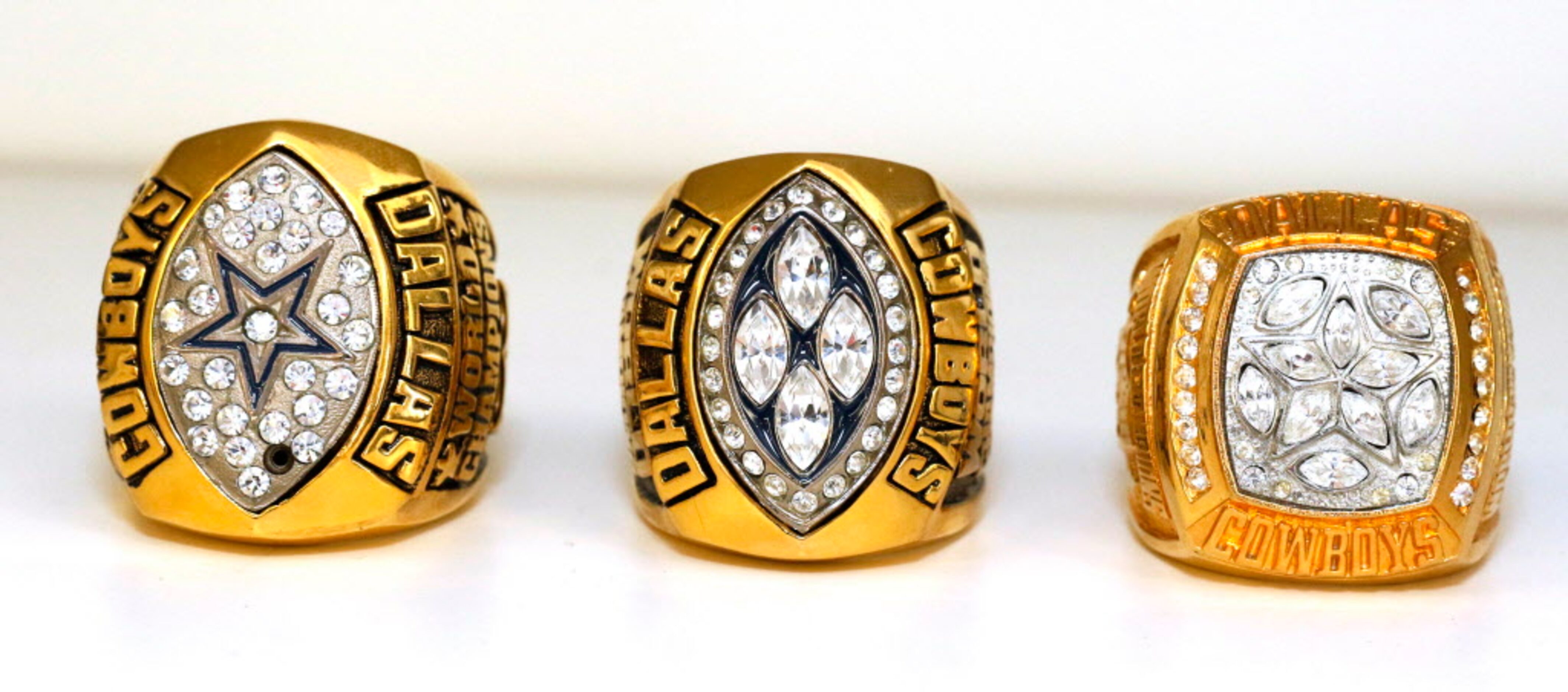 Super Bowl replica rings from 1992, 1993, and 1995 are on display in the game room in his...