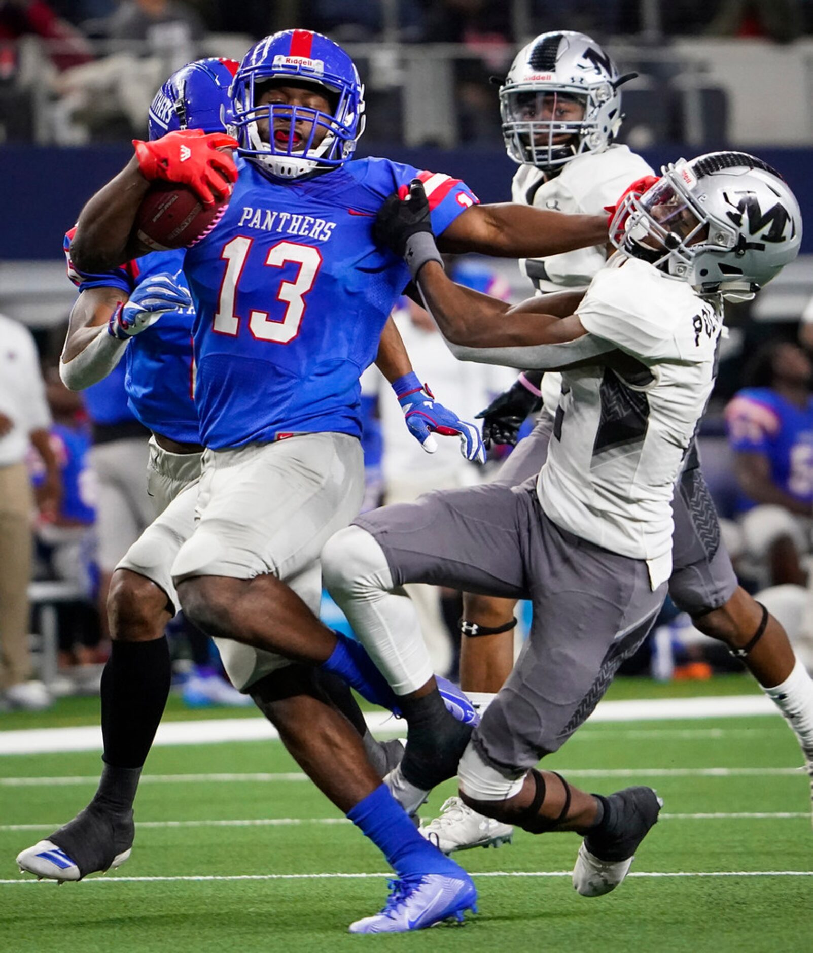 Duncanville wide receiver Roderick Daniels (13) is brought Arlington Martin defensive back...