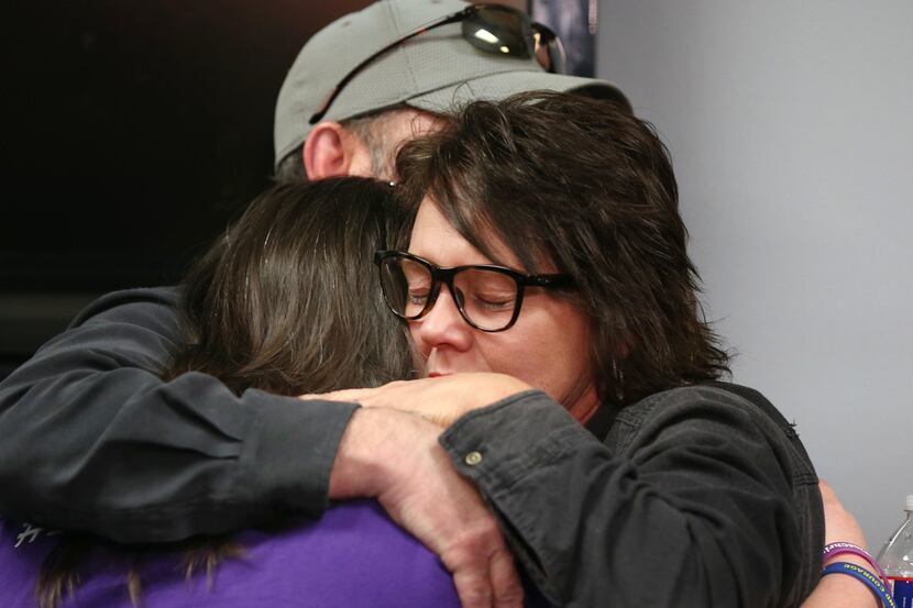 Jonni Hare (right) and Mark Morris, parents of kidnap victim Christina Morris, hug their...