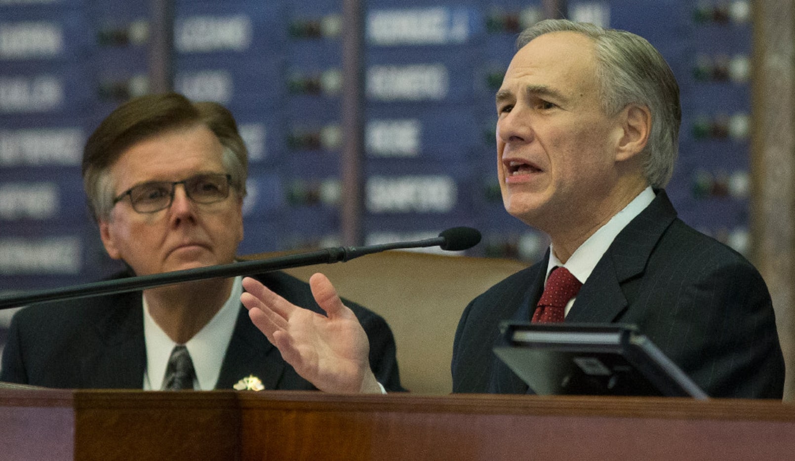 Texas Gov. Greg Abbott, right, delivers his State of the State address to a joint session of...