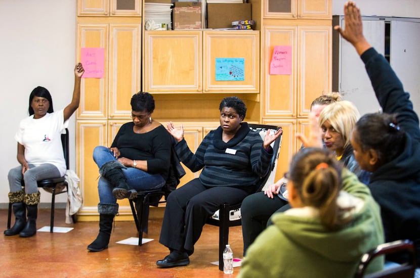 Program manager Monica McGee, center, leads a group session at the Austin Street Center's...