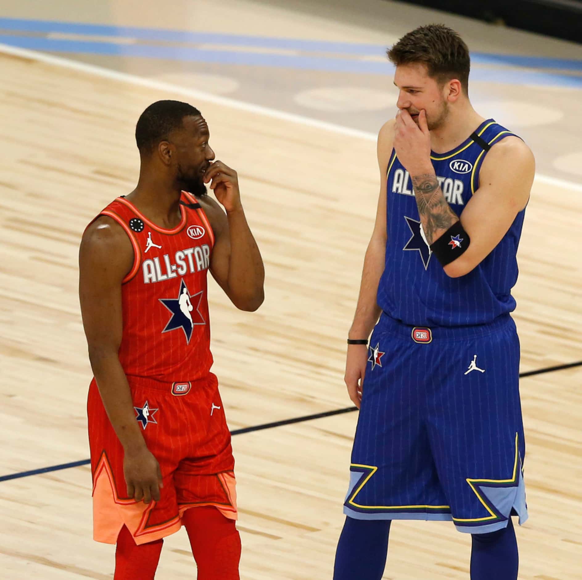 Team LeBron's Luka Doncic (2) and Team Giannis' Kemba Walker (24) talks during a break in...