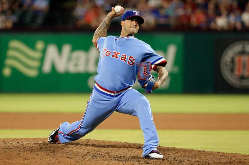 Texas Rangers relief pitcher Matt Bush throws to the Los Angeles Angels in the seventh...