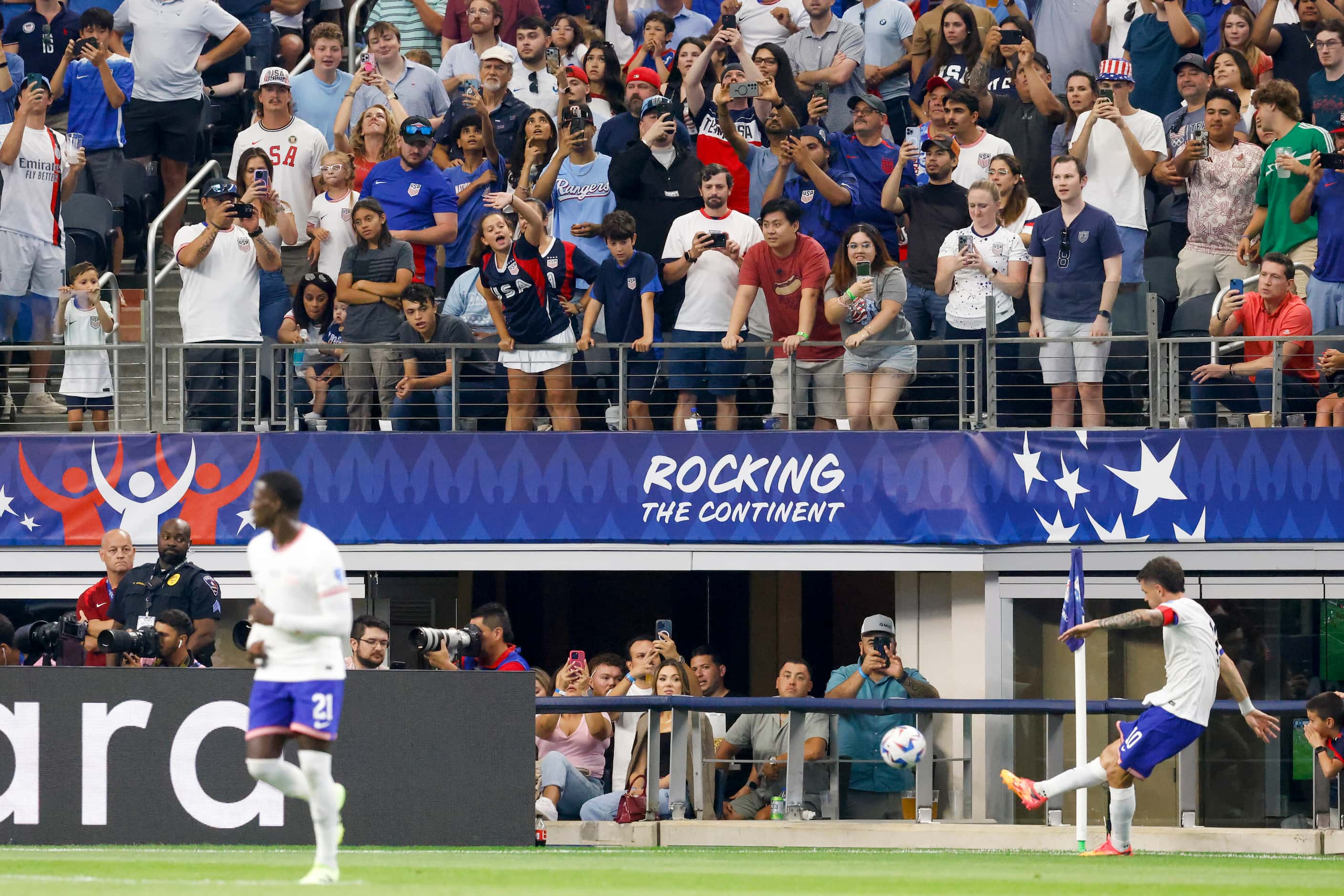 Fans watch as United States forward Christian Pulisic (10) takes a corner kick during the...
