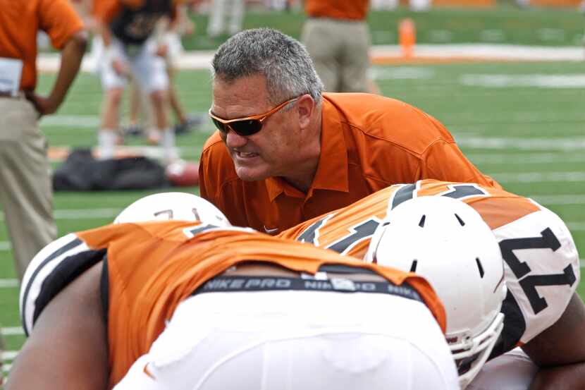 Texas assistant coach Joe Wickline coaches the linemen before the start of the Orange and...