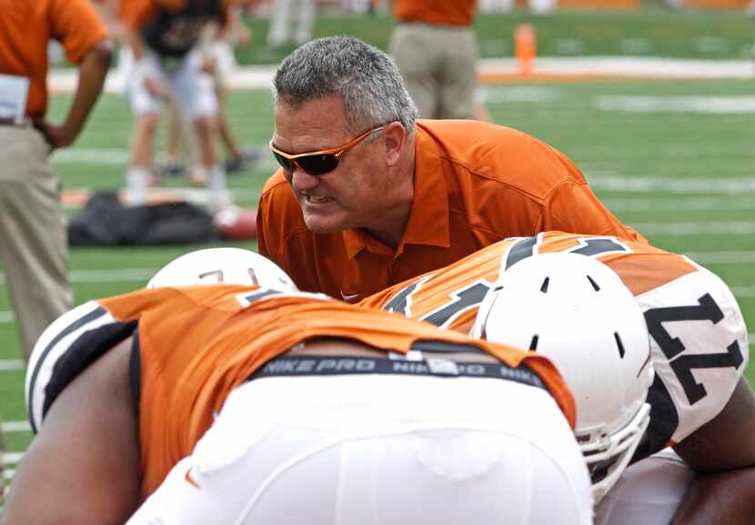 Texas assistant coach Joe Wickline coaches the linemen before the start of the Orange and...