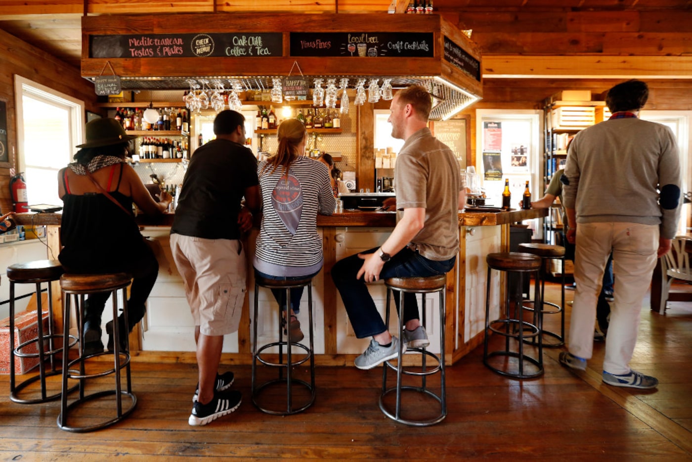 People take a seat at the bar for conversation and drinks at The Wild Detectives bookstore...