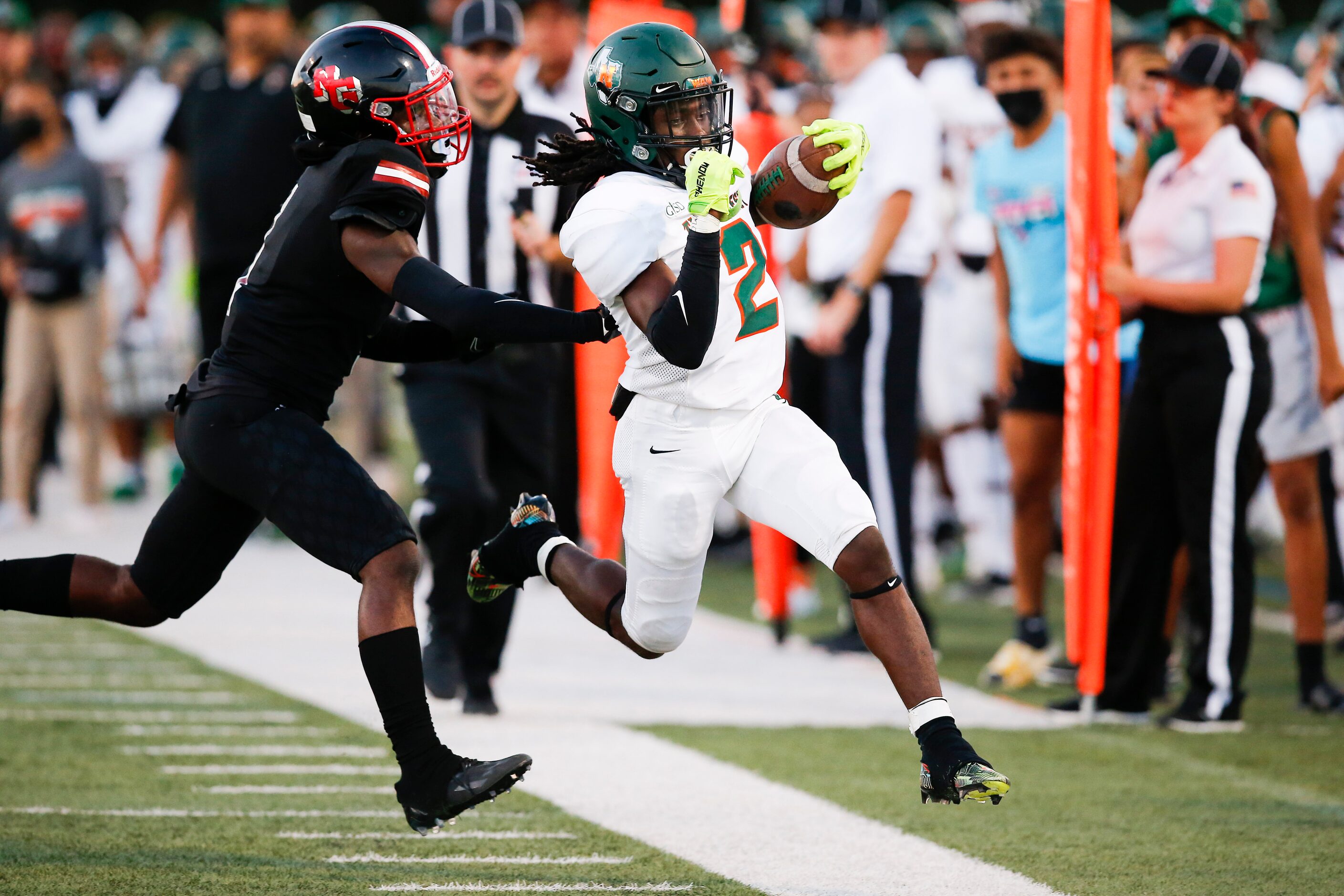 North Garland sophomore linebacker Mateo Howard, left, forces Garland Naaman Forest senior...