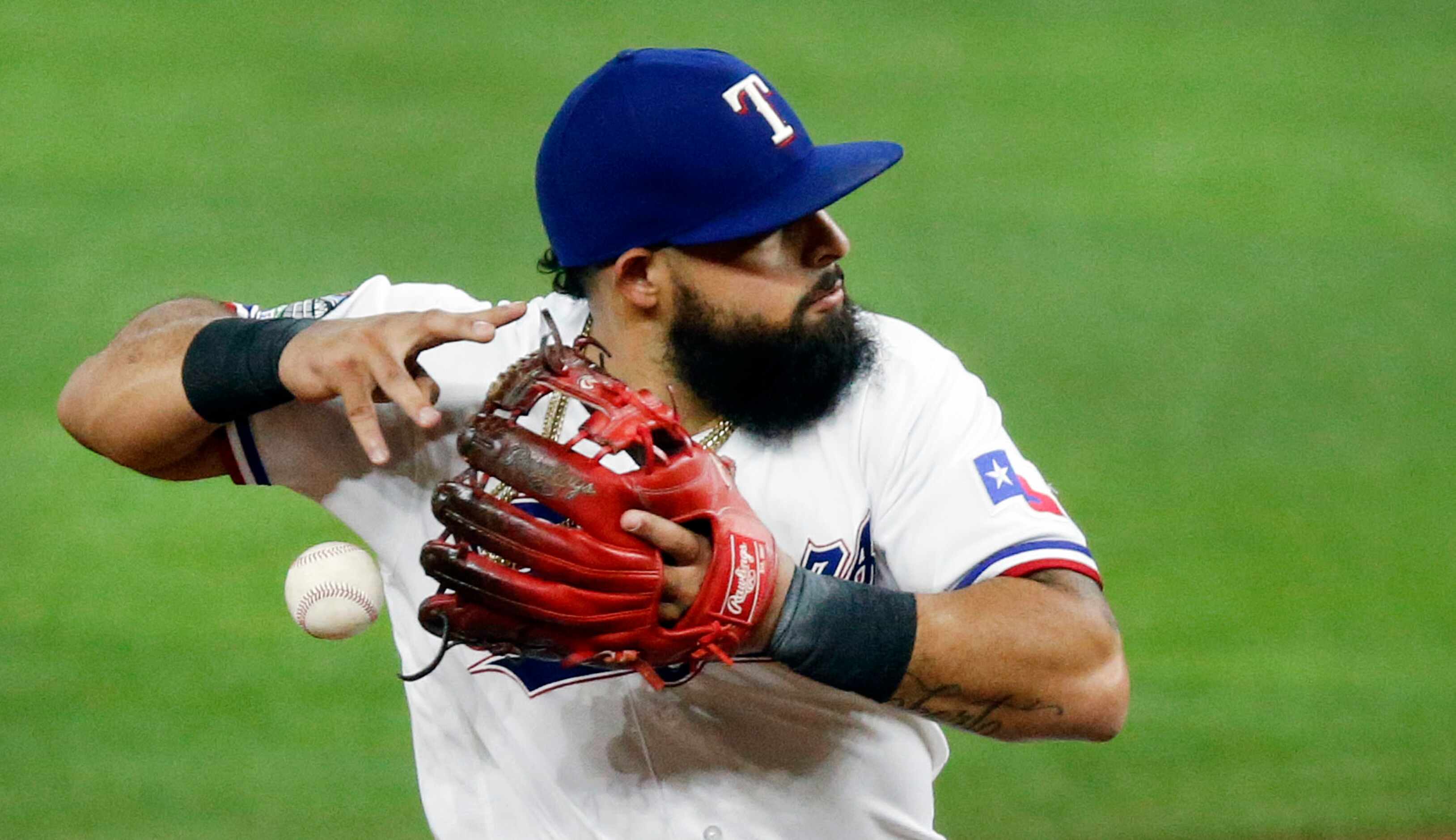 Texas Rangers second baseman Rougned Odor (12) has trouble turning the front end of a double...