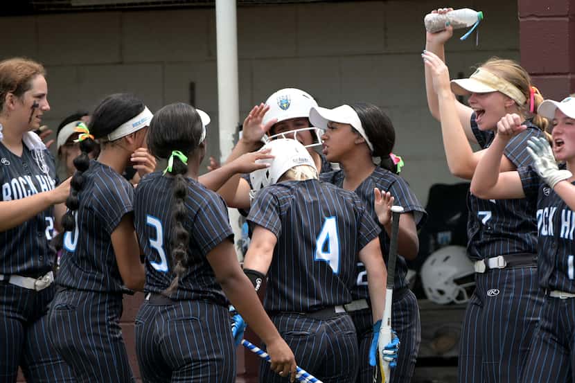 Prosper Rock Hill's Leah Rinehart (4) is congratulated by teammates after scoring a run in...